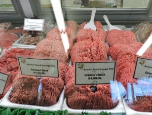 Raw Ground Beef Behind Butcher Counter | Gourmet Meat and Sausage
